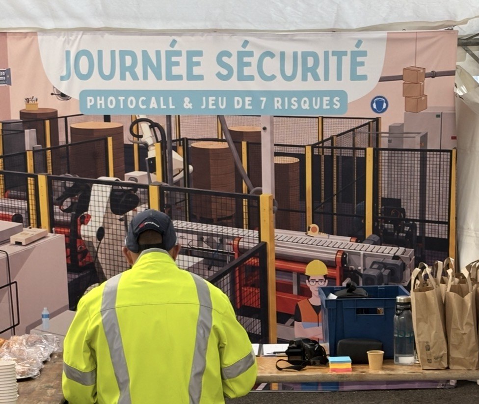 Stand de la semaine sécurité d’un site industriel papetier, avec un salarié devant un décor de sensibilisation aux risques